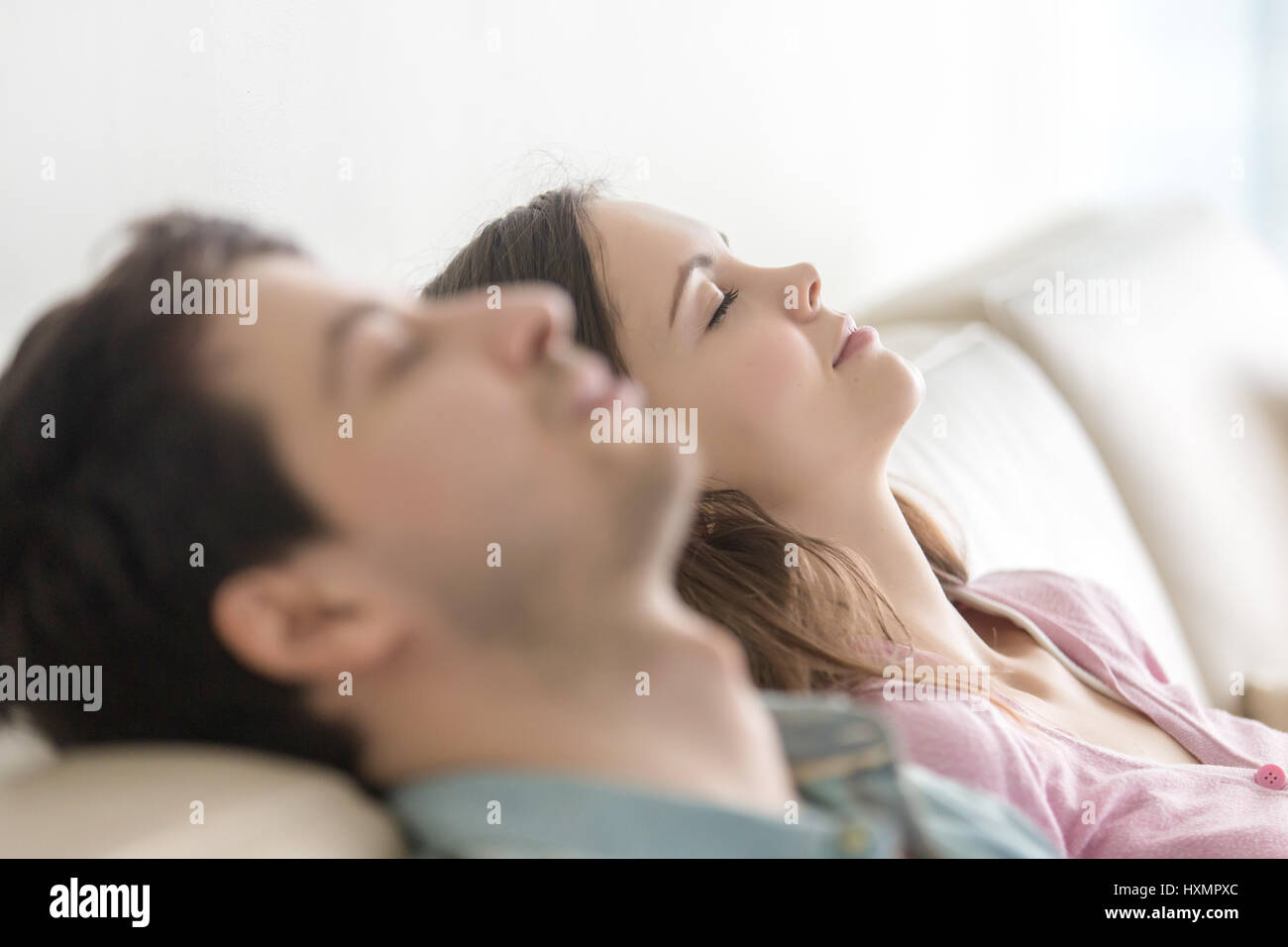 Happy young people relaxing with eyes closed, enjoying, side vie Stock Photo