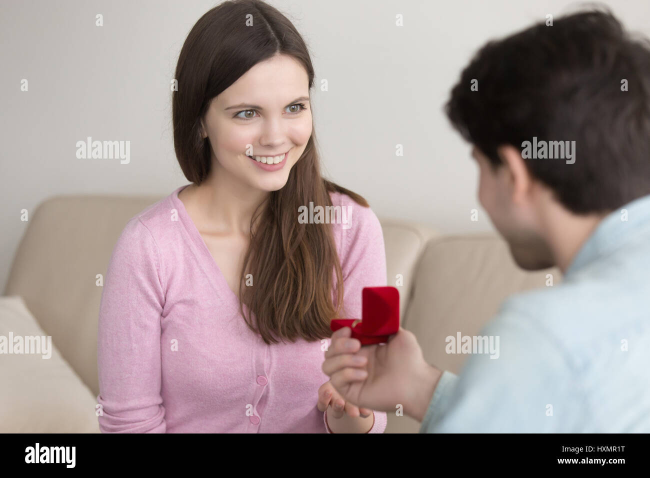 Young man holding box with engagement ring, making marriage prop Stock Photo