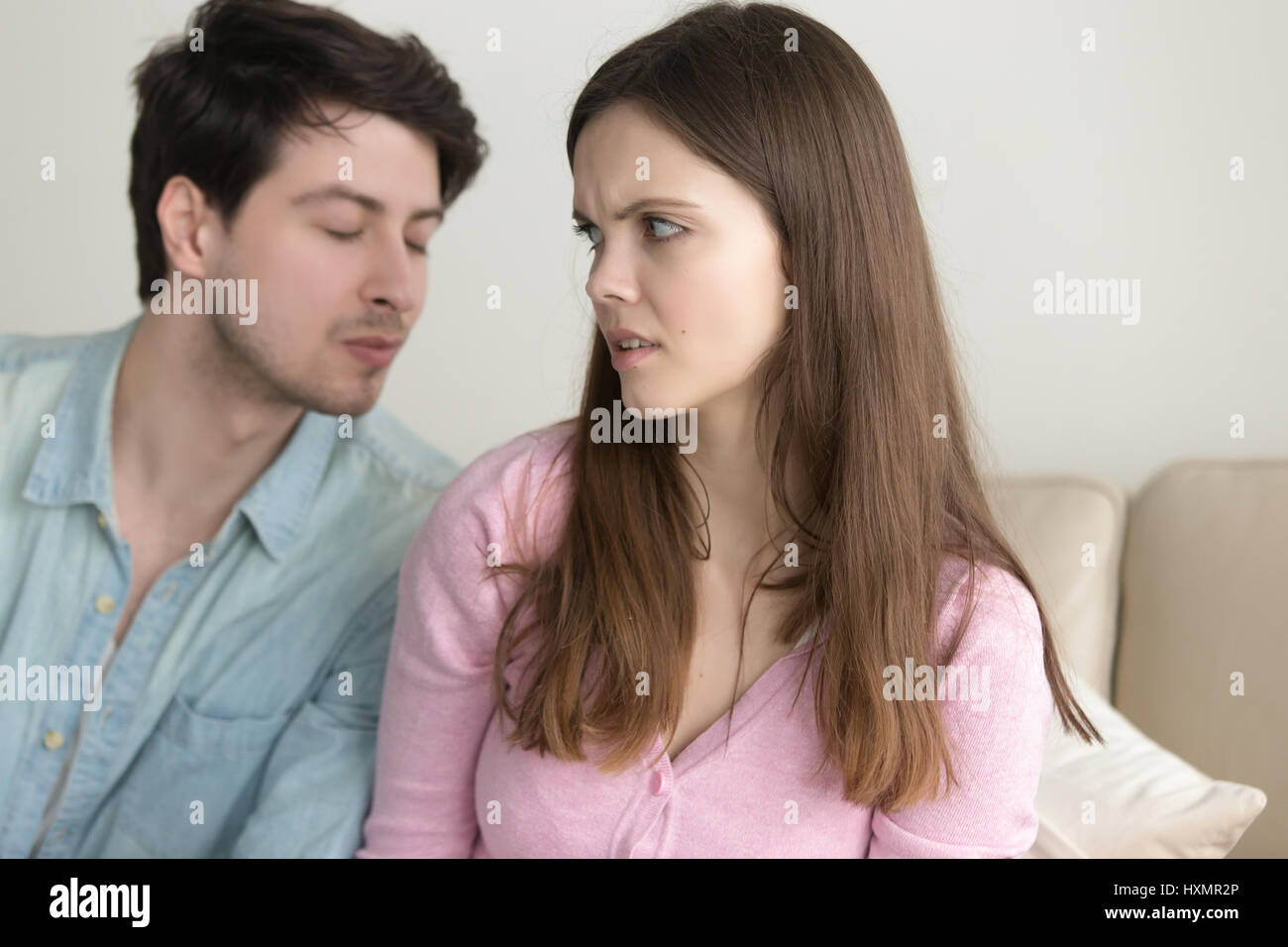Man trying to kiss woman, she rejecting him, friend zone Stock Photo