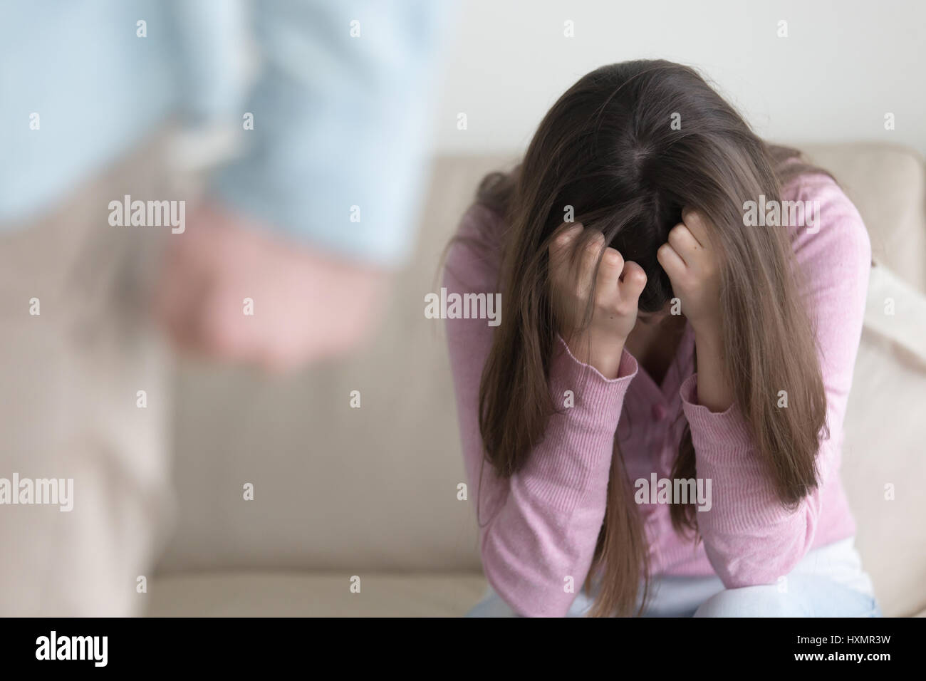 Unhappy couple breaking up, man leaving sad woman, domestic abus Stock Photo