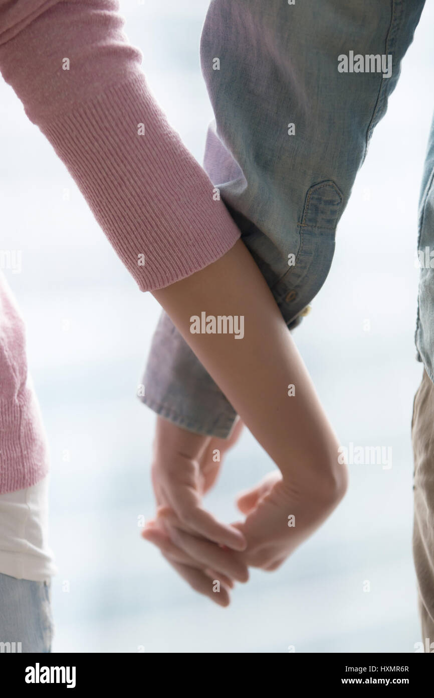 Young couple holding hands, closeup. Love, support, family, rela Stock Photo