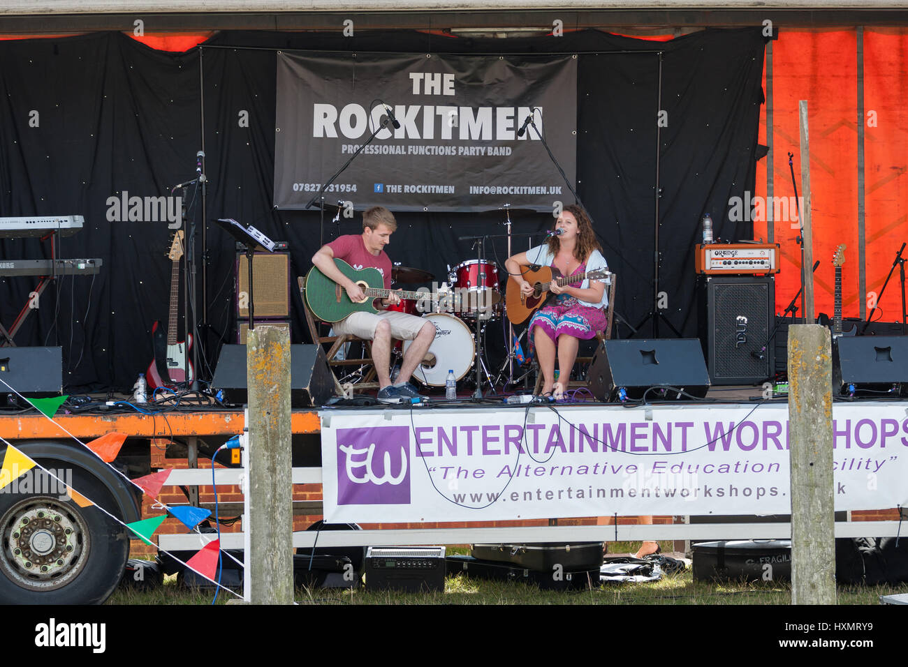 The Rye Maritime Festival held in August in this 1066 country town the rockitmen stage party band local woman singing guitar vocalist. Rye East Sussex Stock Photo