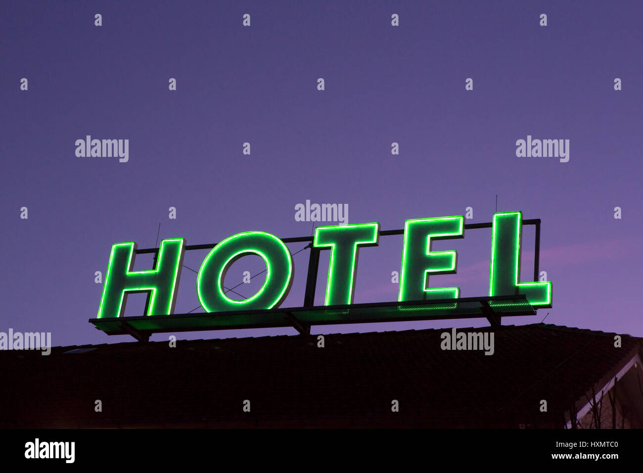Green neon sign of a Hotel Stock Photo