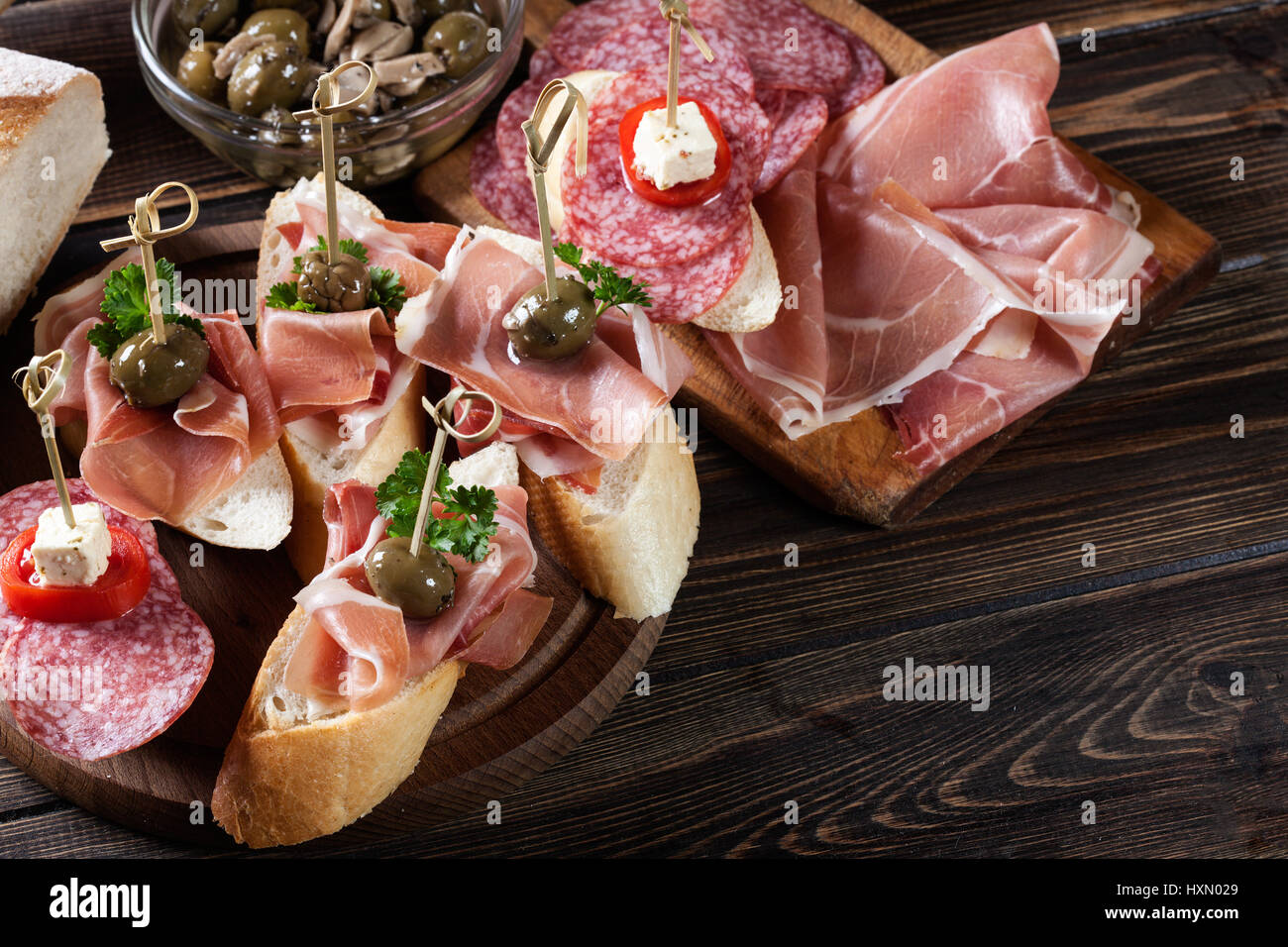 Spanish tapas with slices jamon serrano, salami, olives and cheese ...