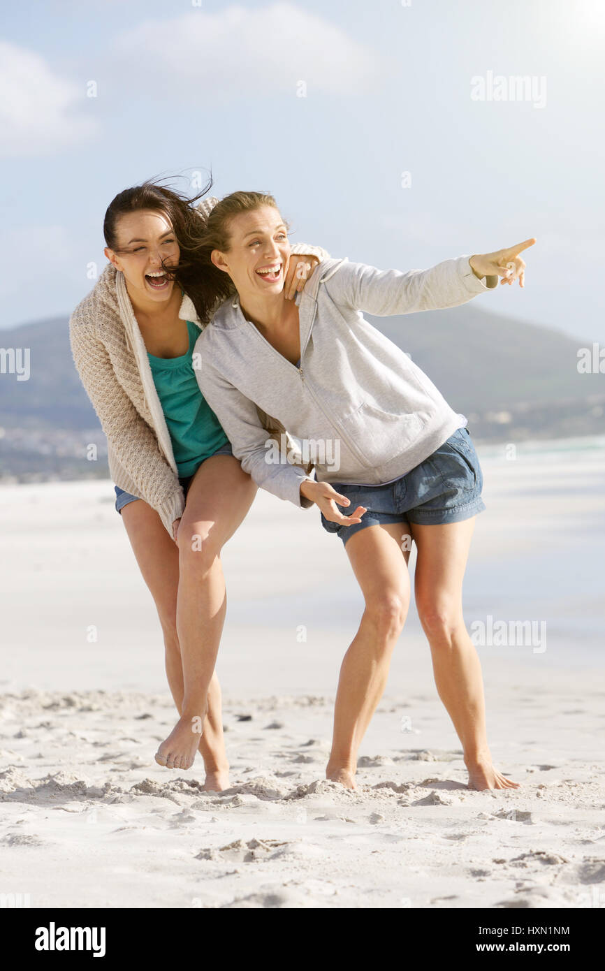 Portrait of two friends enjoying life at the beach together Stock Photo ...