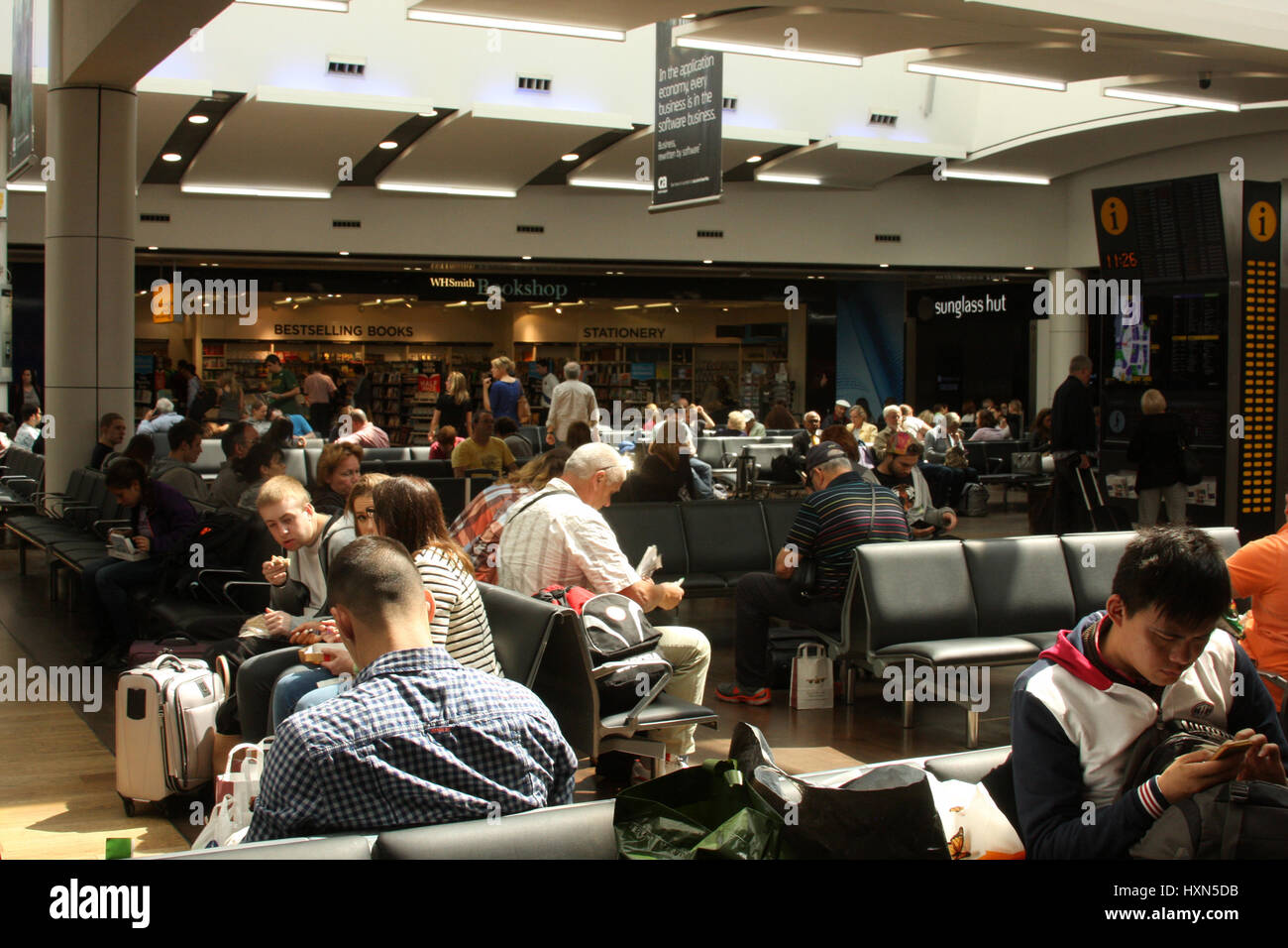 Airport passengers sitting hi-res stock photography and images - Alamy