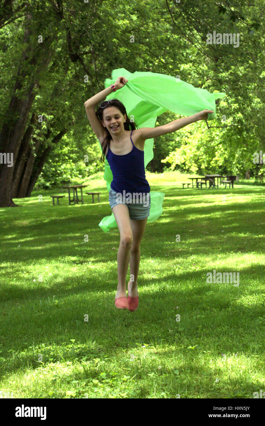 Young skinny girl running happy in park Stock Photo