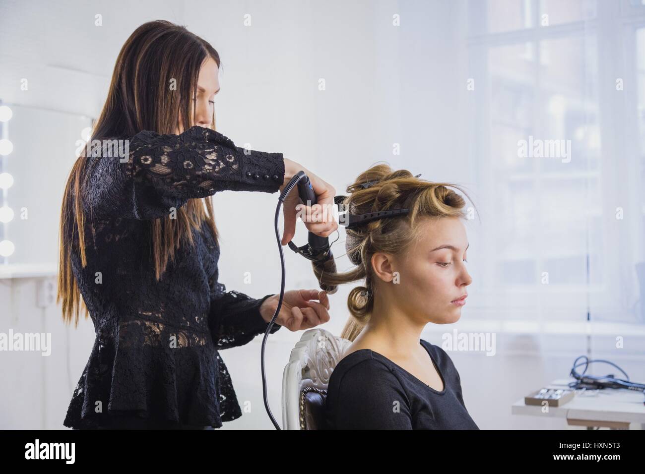 Professional Hairdresser Stylist Making Curls In White Make Up