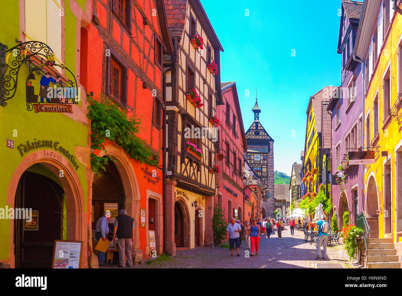 Riquewihr, France-June 23, 2016: Tourists are walking on the main shopping street; Rue du General de Gaulle, in Riquewihr, Alsace France Stock Photo