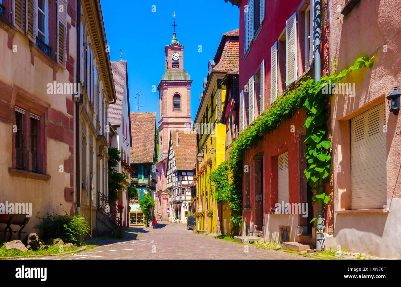 Picturesque street with charming traditional houses in Riquewihr village on the wine route, France Stock Photo