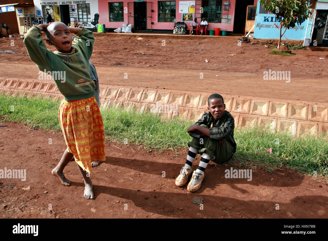 Makuyuni, Arusha, Tanzania - February 13, 2008: Unidentified African children, two unknown black girls, the approximate age of 10 years old, resting o Stock Photo