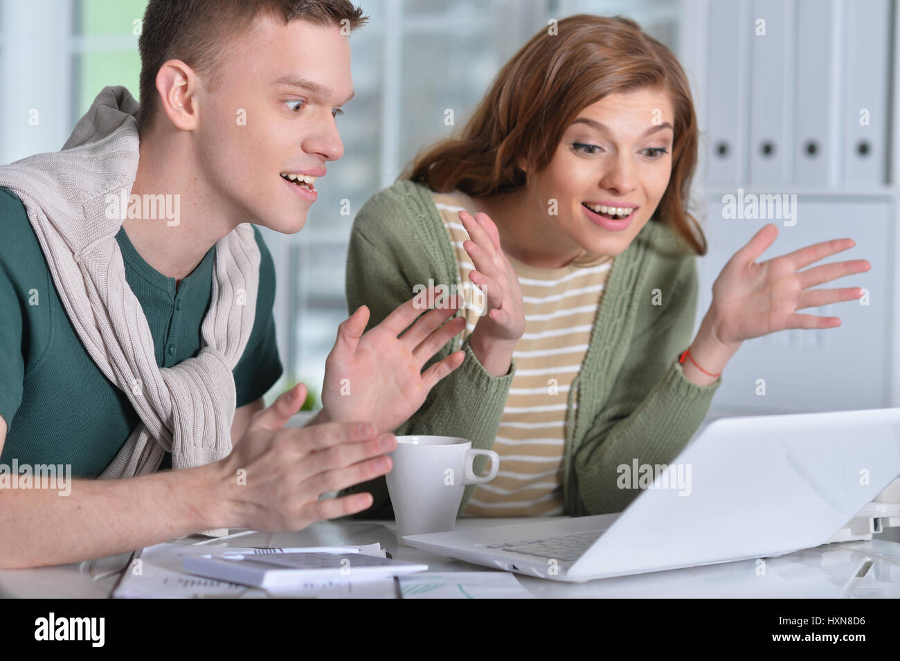 Beautiful young couple with a laptop Stock Photo - Alamy