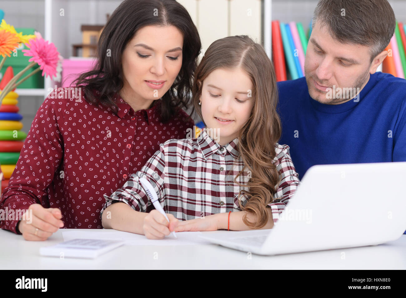 Family with a daughter using a laptop Stock Photo