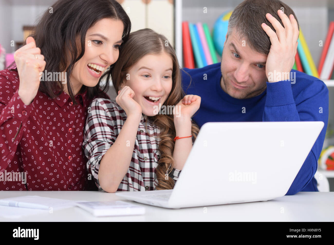 Family with a daughter using a laptop Stock Photo