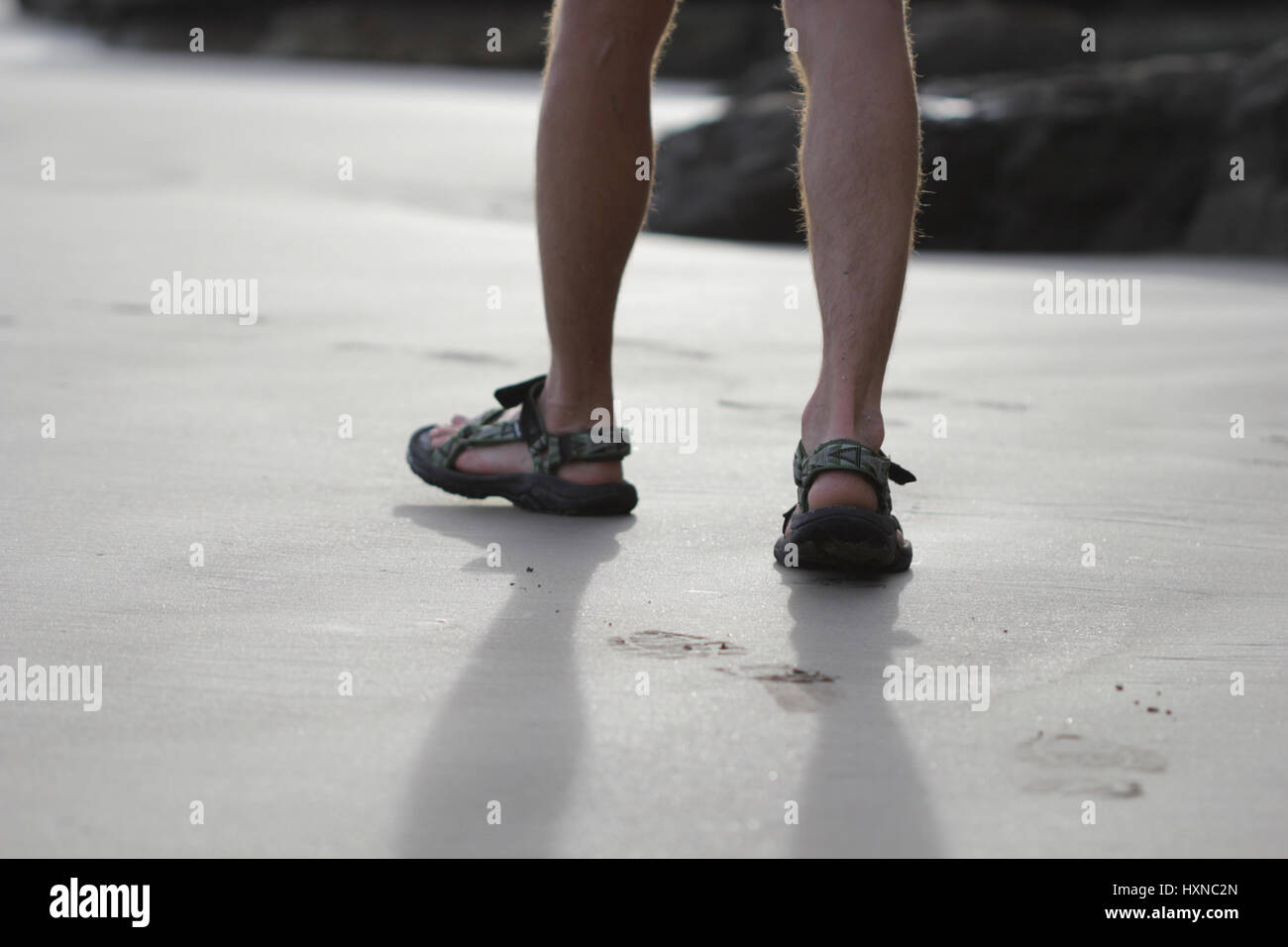 Young men feet on the beach wearing sandals Stock Photo Alamy