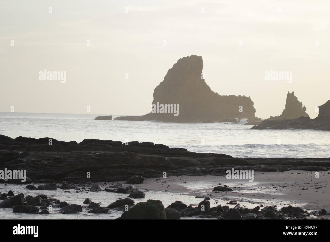 Rocks and cliffs inside the ocean at sunset Stock Photo - Alamy