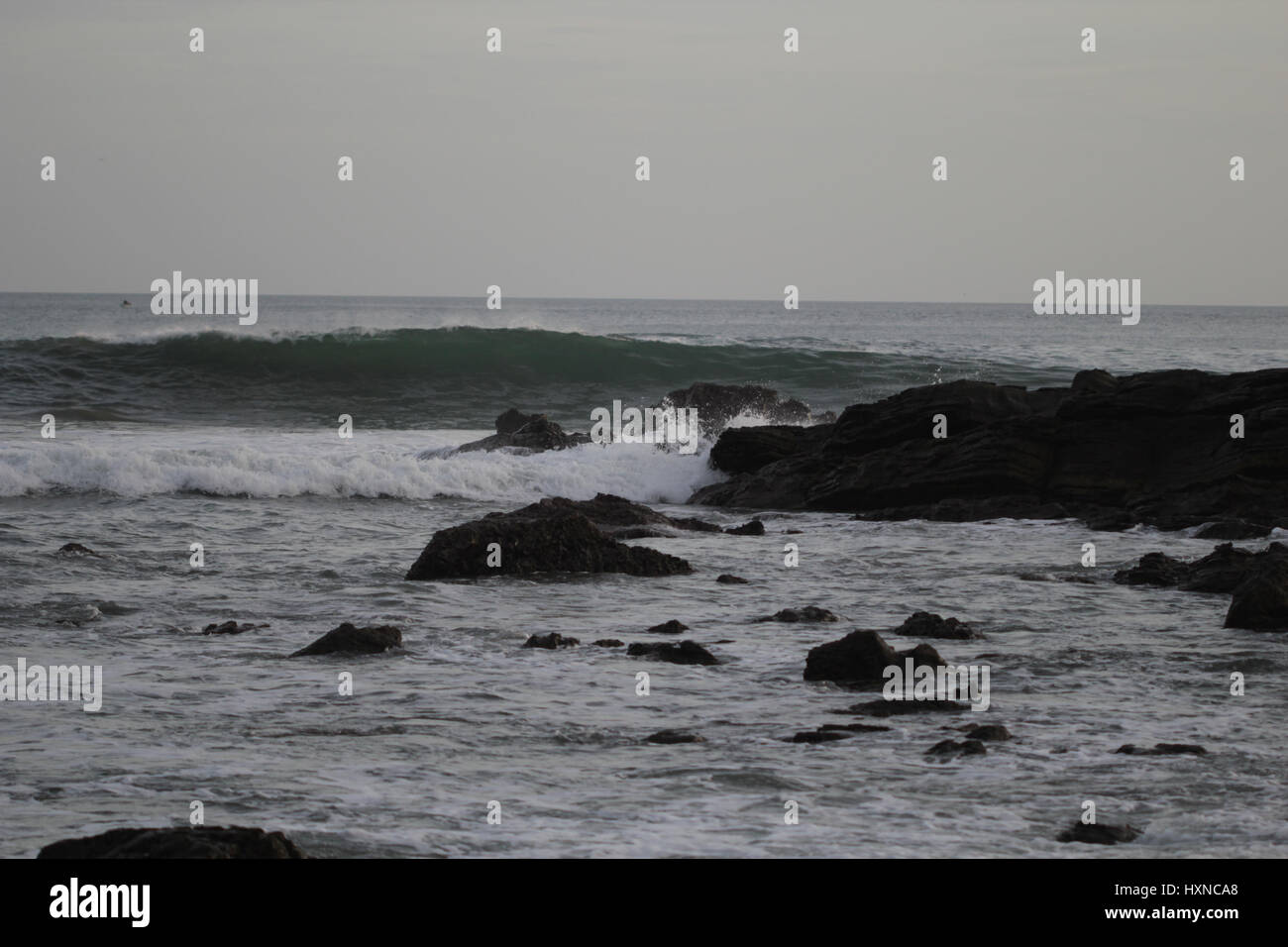 Rocks and cliffs inside the ocean at sunset Stock Photo - Alamy
