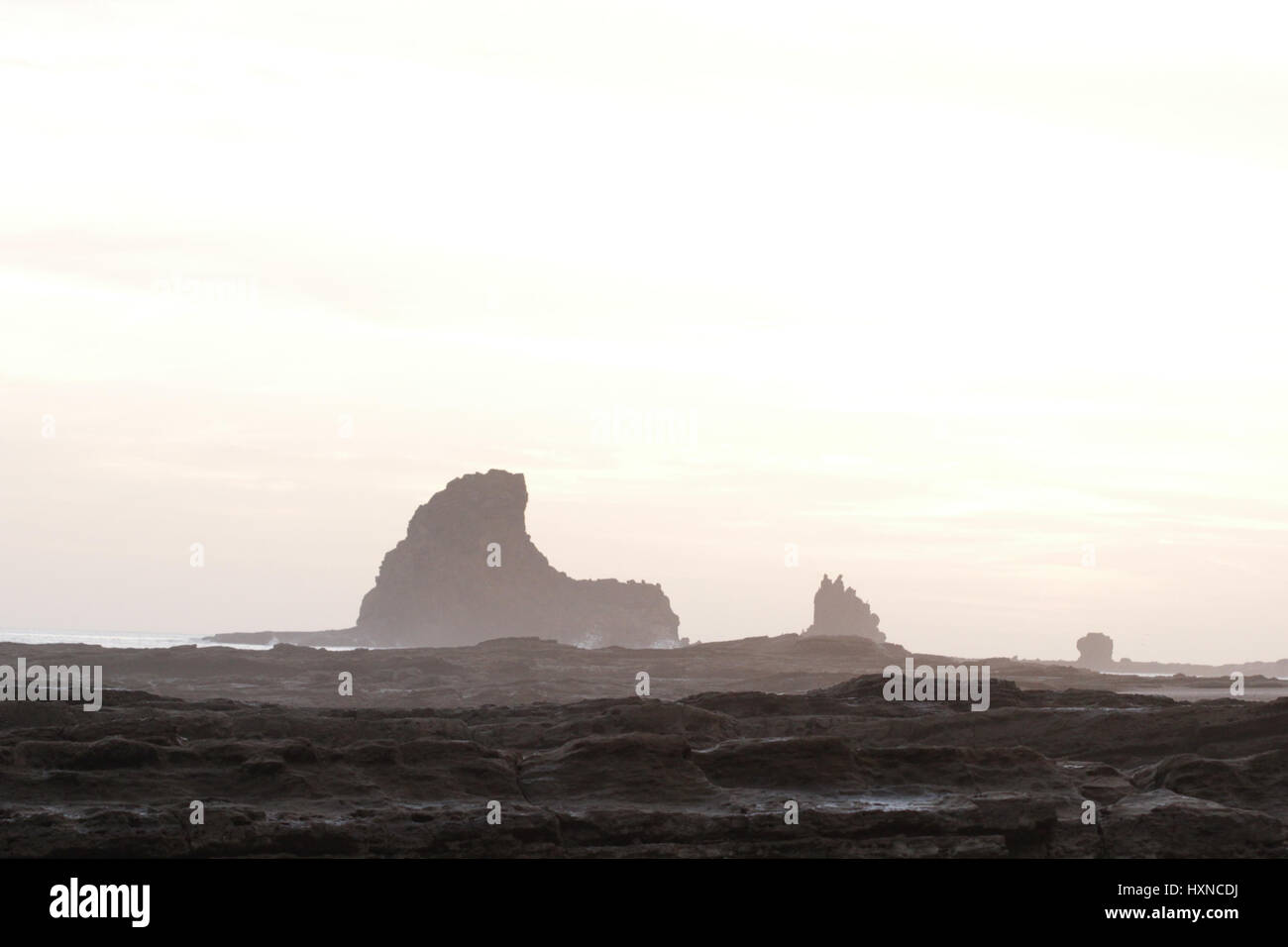 Rocks and cliffs inside the ocean at sunset Stock Photo - Alamy