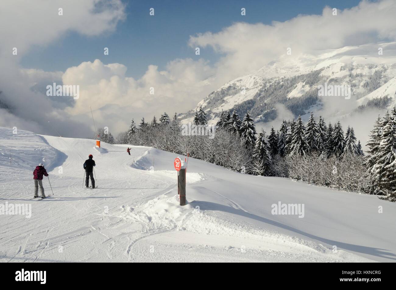 Skiers on a red piste, Hauteluce / Les Contamines ski area, Savoie, France, February. Stock Photo