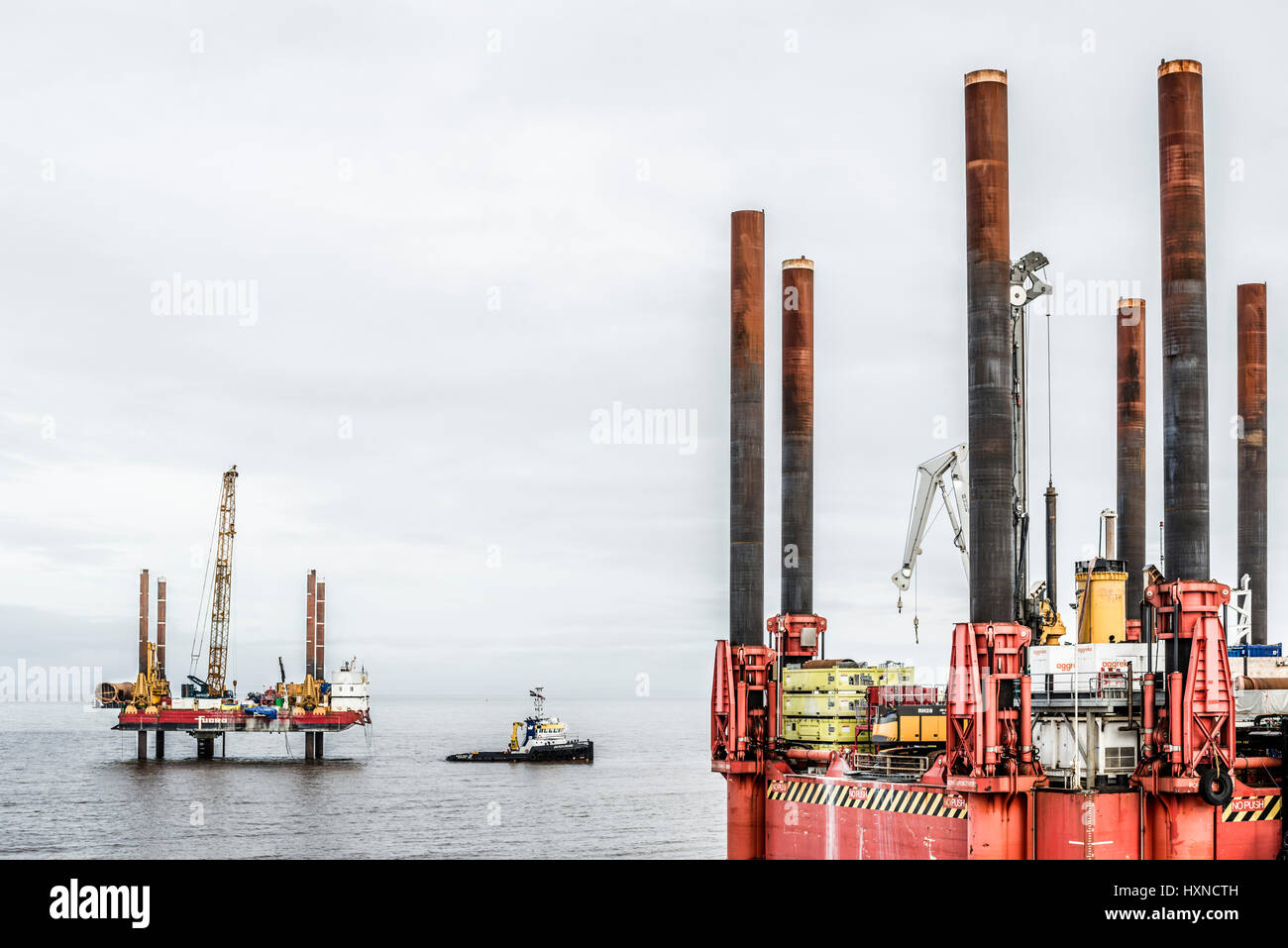 Offshore rigs and boat in the Bristol channel,druring the construction of Hinhley C power station. Stock Photo