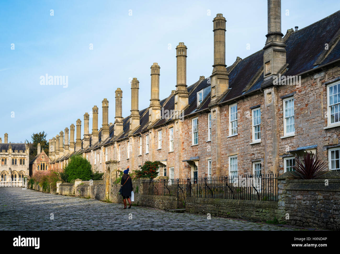 A woman walking down Vicors close, Wells, Somerset Stock Photo