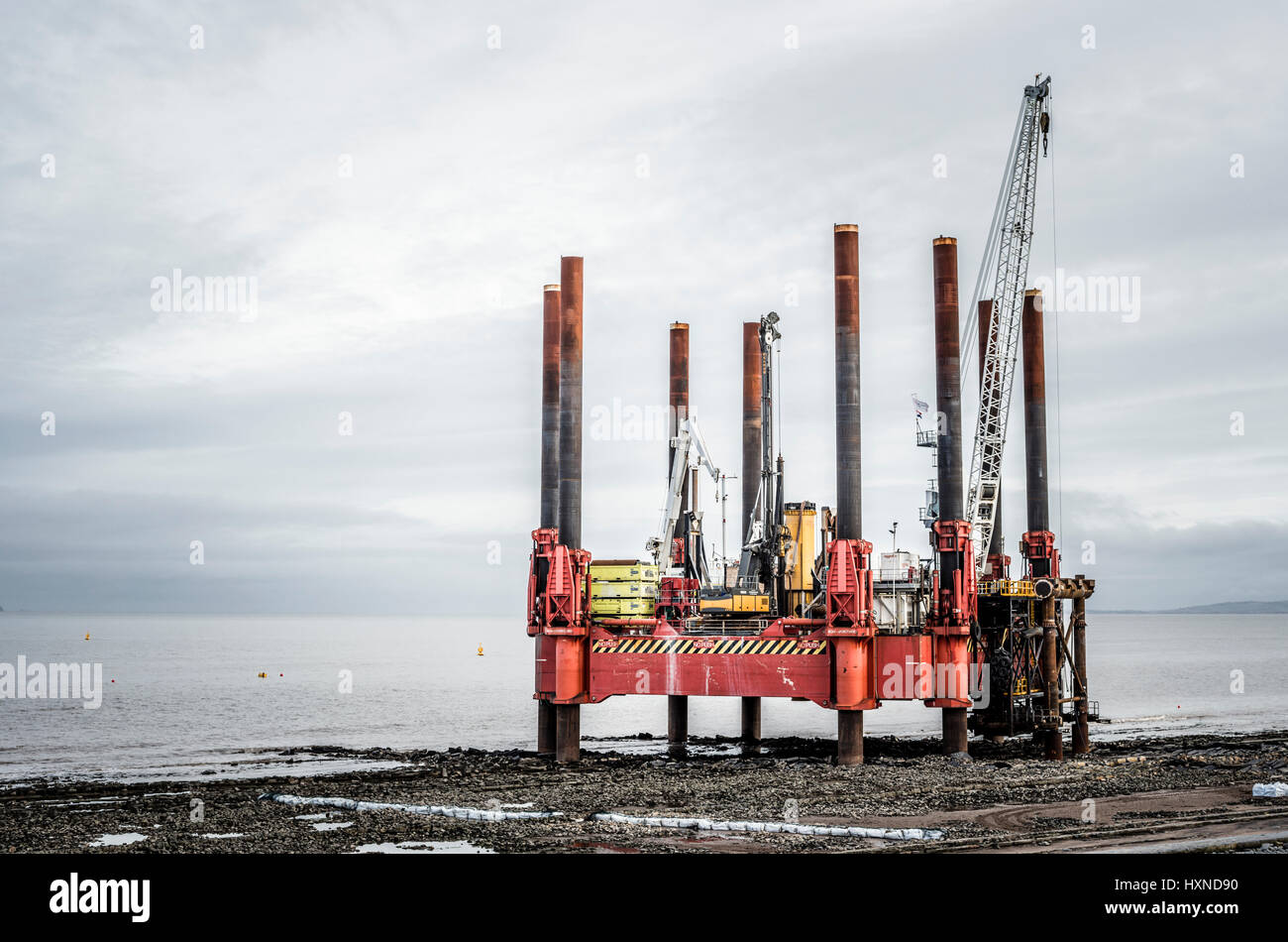 Offshore rigs at low tide on the Bristol channel,druring the construction of Hinhley C power station. Stock Photo