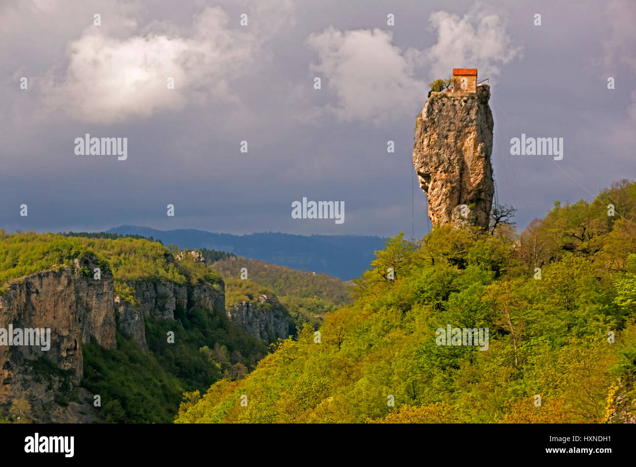 Katskhi Pillar, natural limestone monolith, with single hermit monk's house on top. Stock Photo