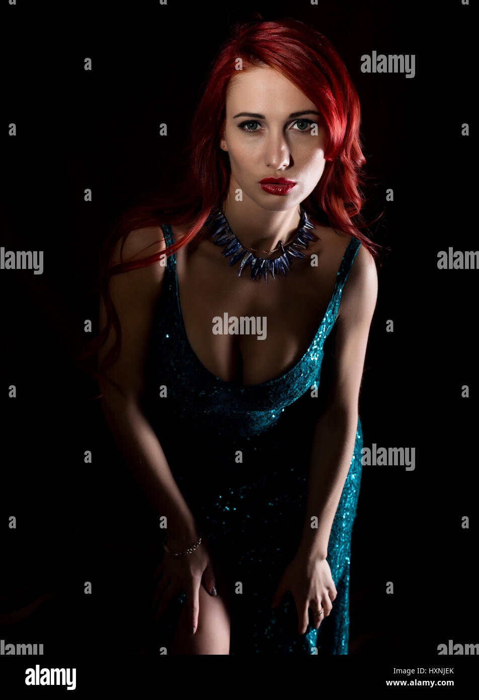 beautiful redhead woman with big tits in a tight dress posing on a dark background Stock Photo - Alamy beautiful redhead woman with big tits in a tight dress posing on a dark background Stock Photo - Alamy