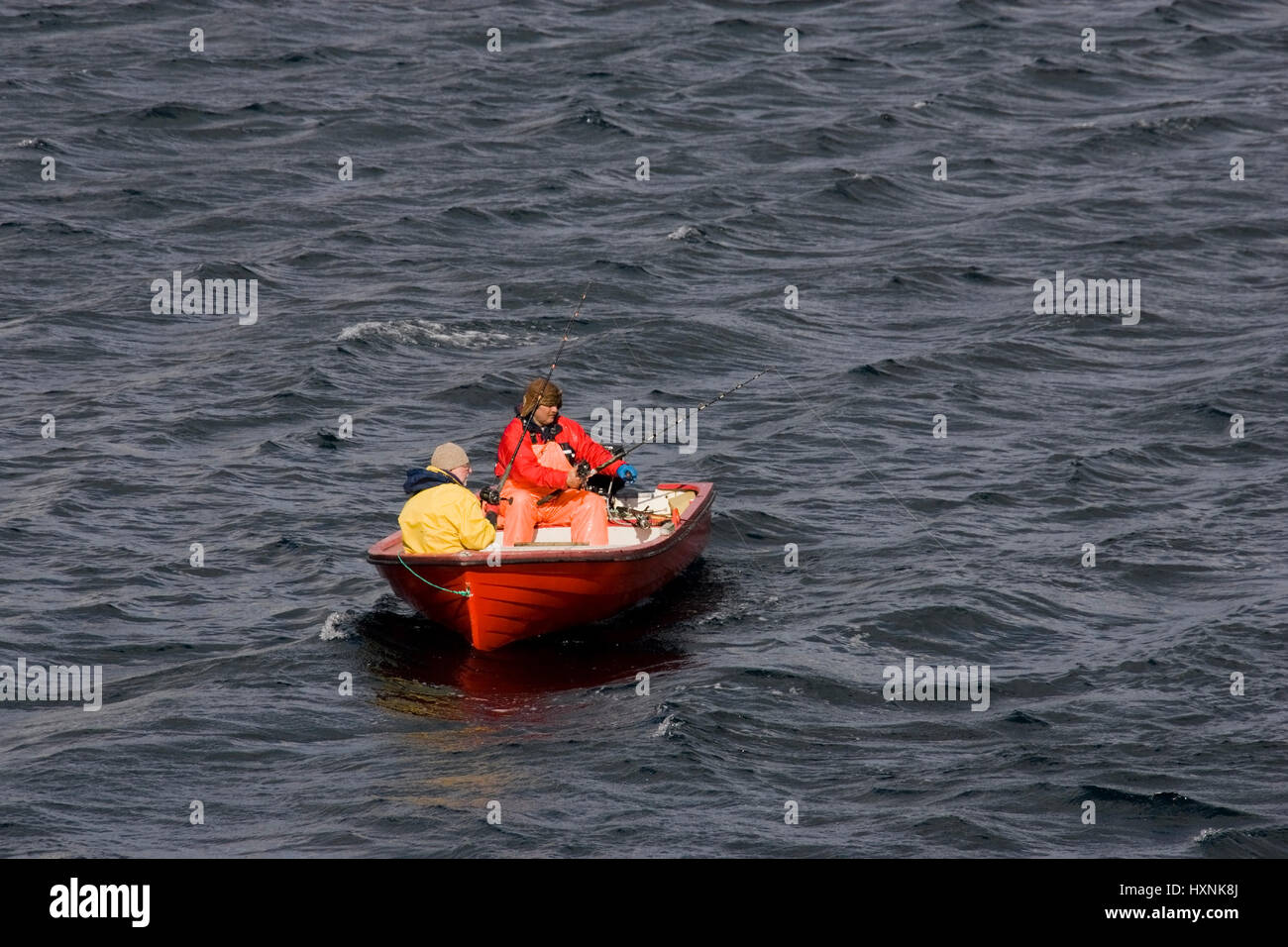 Fscher in the red fishing boat, Fscher im roten Fischerboot  Sakrisoy, Lofoten Stock Photo