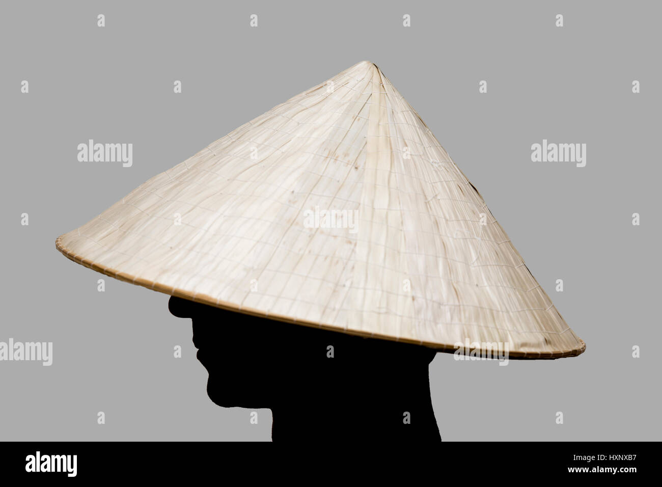 Man with traditional hat from Asia made of wicker Stock Photo