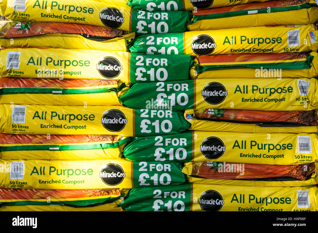 A stack of MiracleGro All Purpose Enriched Compost bags for sale in a