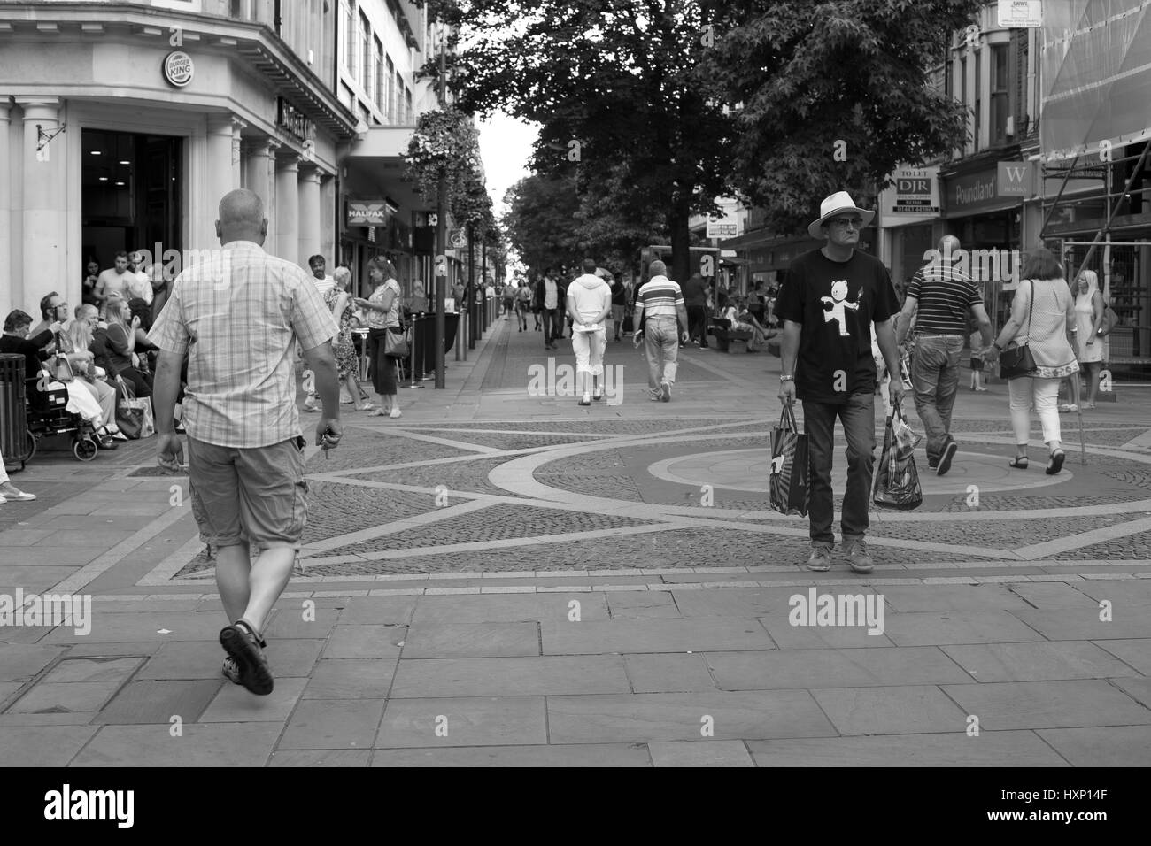 man with shopping wearing teddybear bomb shirt on street Stock Photo