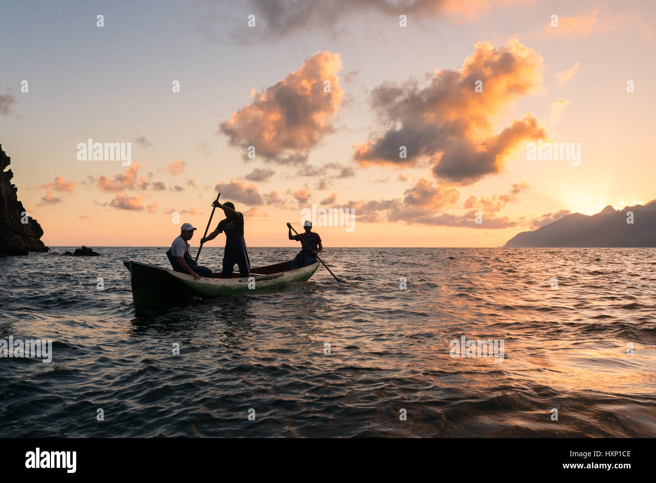 Fishermen paddling a dugout canoe off Brazil Stock Photo