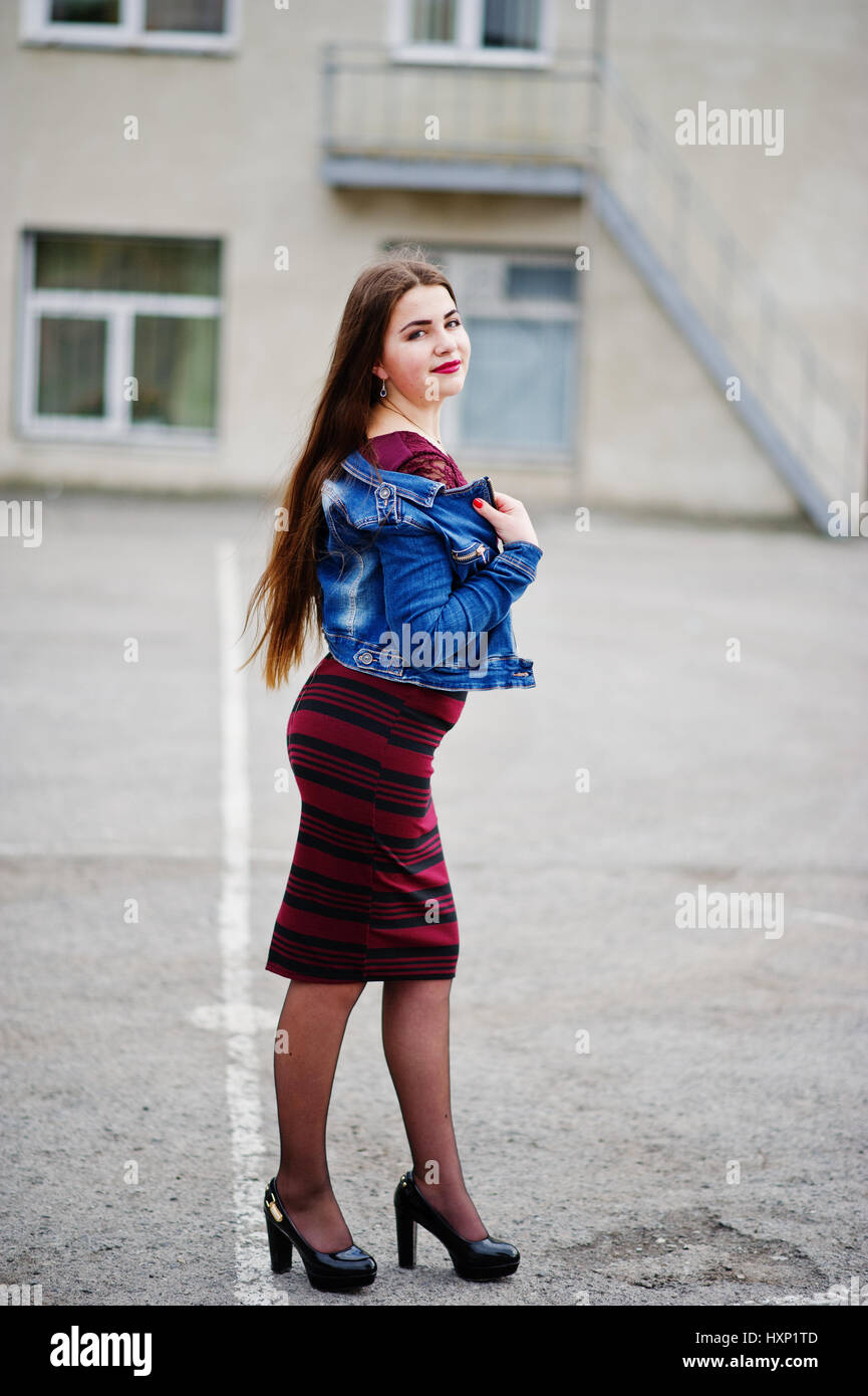 Young chubby teenage girl wear on red dress and jeans jacket posed