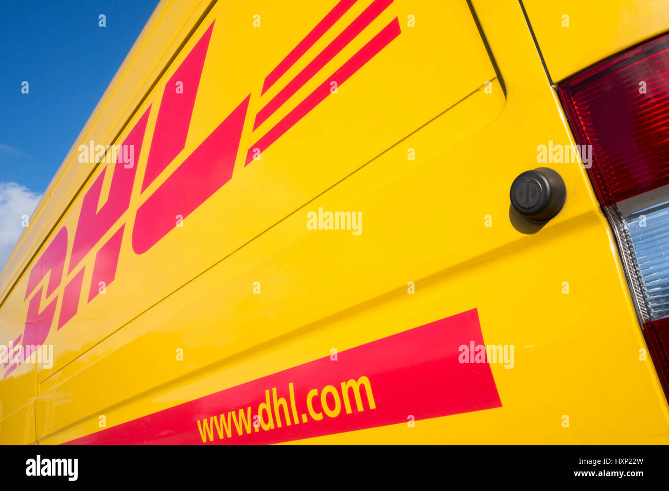 Side panel of a DHL delivery van. DHL is a division of the German logistics company Deutsche Post AG providing international express mail services. Stock Photo