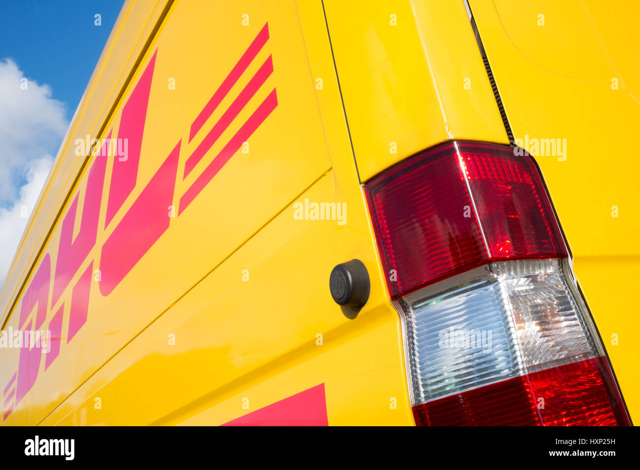 Side panel of a DHL delivery van. DHL is a division of the German logistics company Deutsche Post AG providing international express mail services. Stock Photo