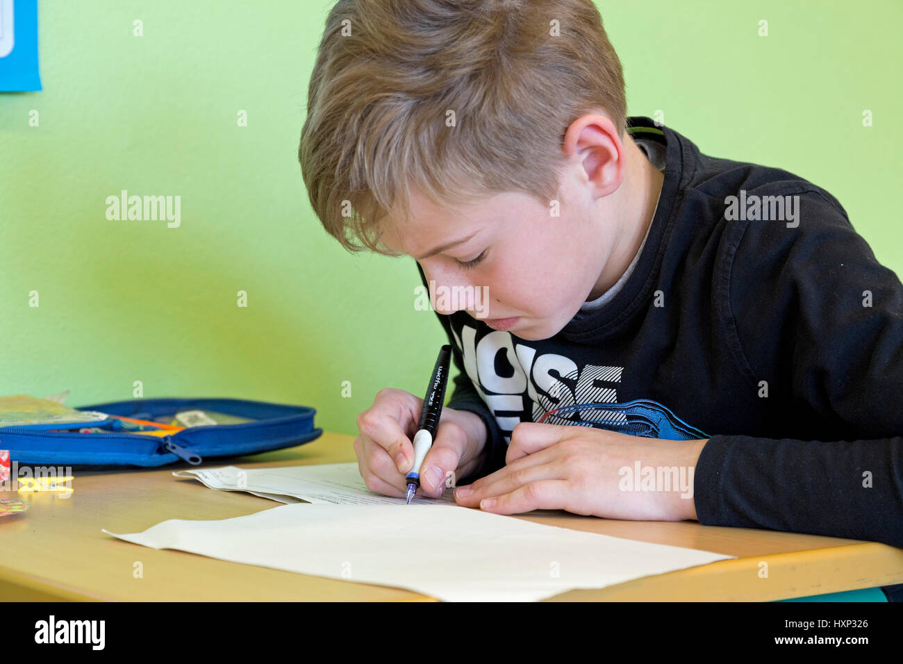 boy writing a test at primary school Stock Photo