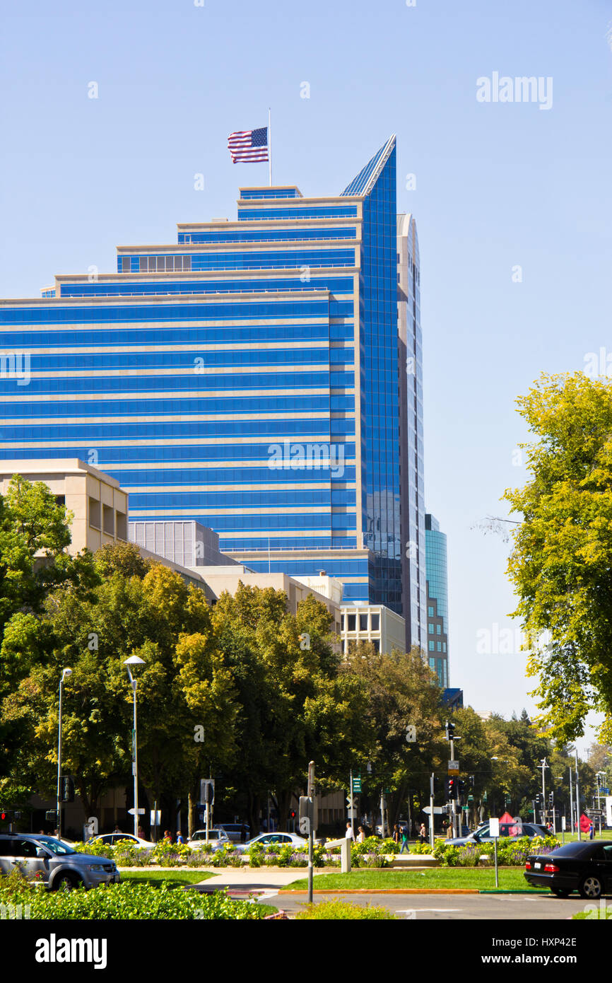 Sacramento sky scrapper with American flag flying at half staff. Stock Photo