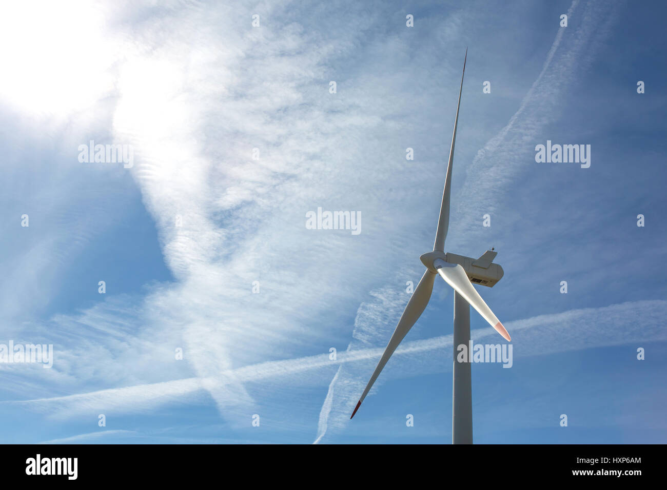 Wind turbine on cloudy blue sky Stock Photo - Alamy