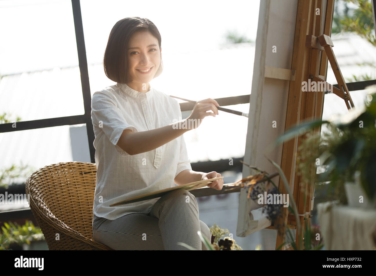 Young woman painting at studio Stock Photo - Alamy