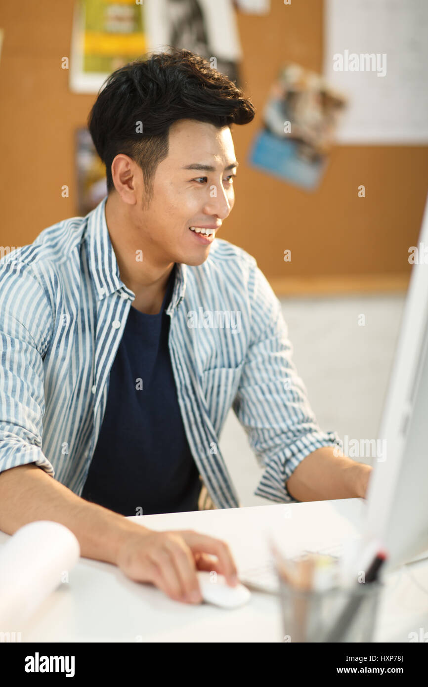 Young man using computer at home Stock Photo - Alamy