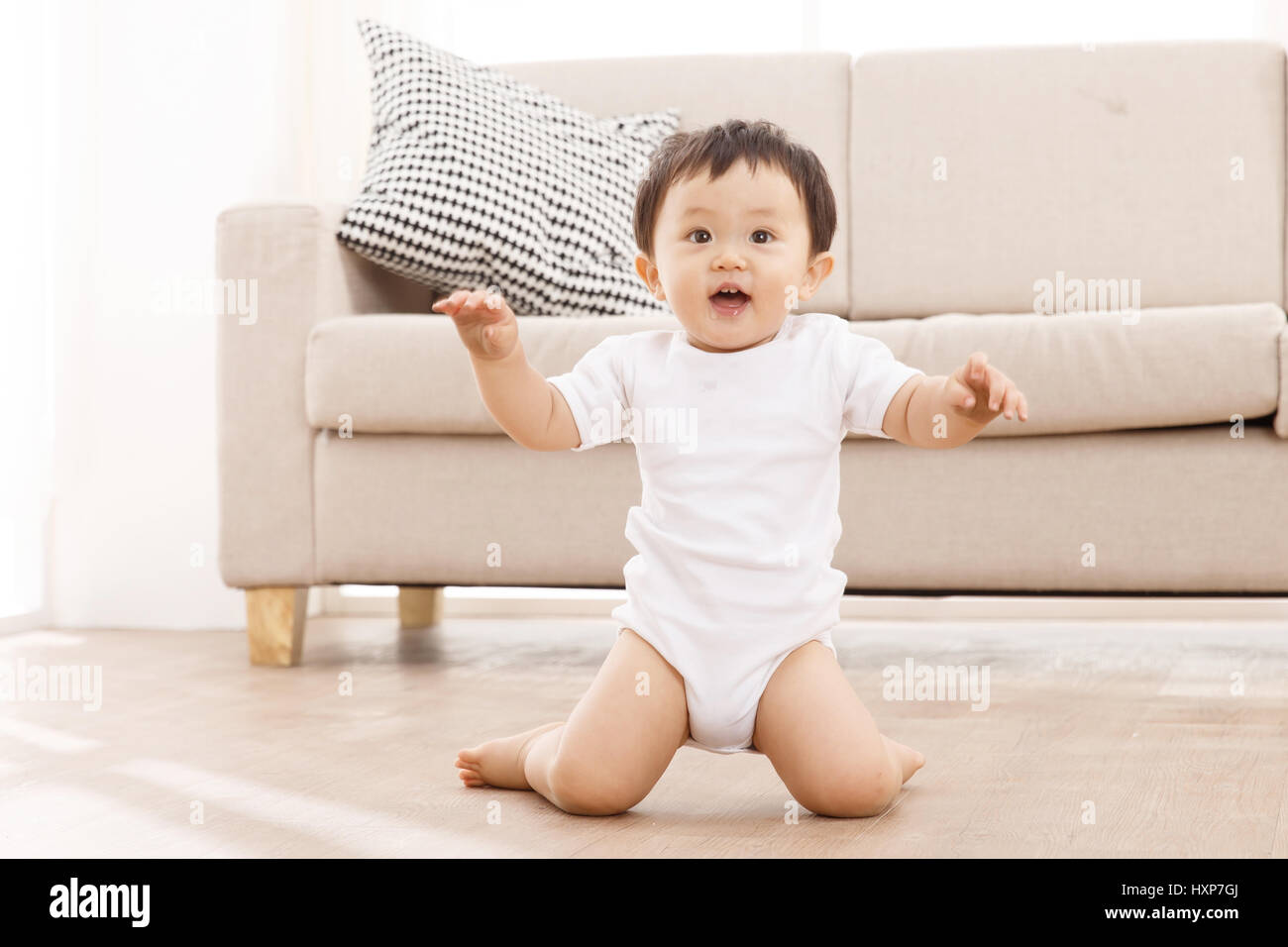 Baby boy kneeling on floor Stock Photo Alamy