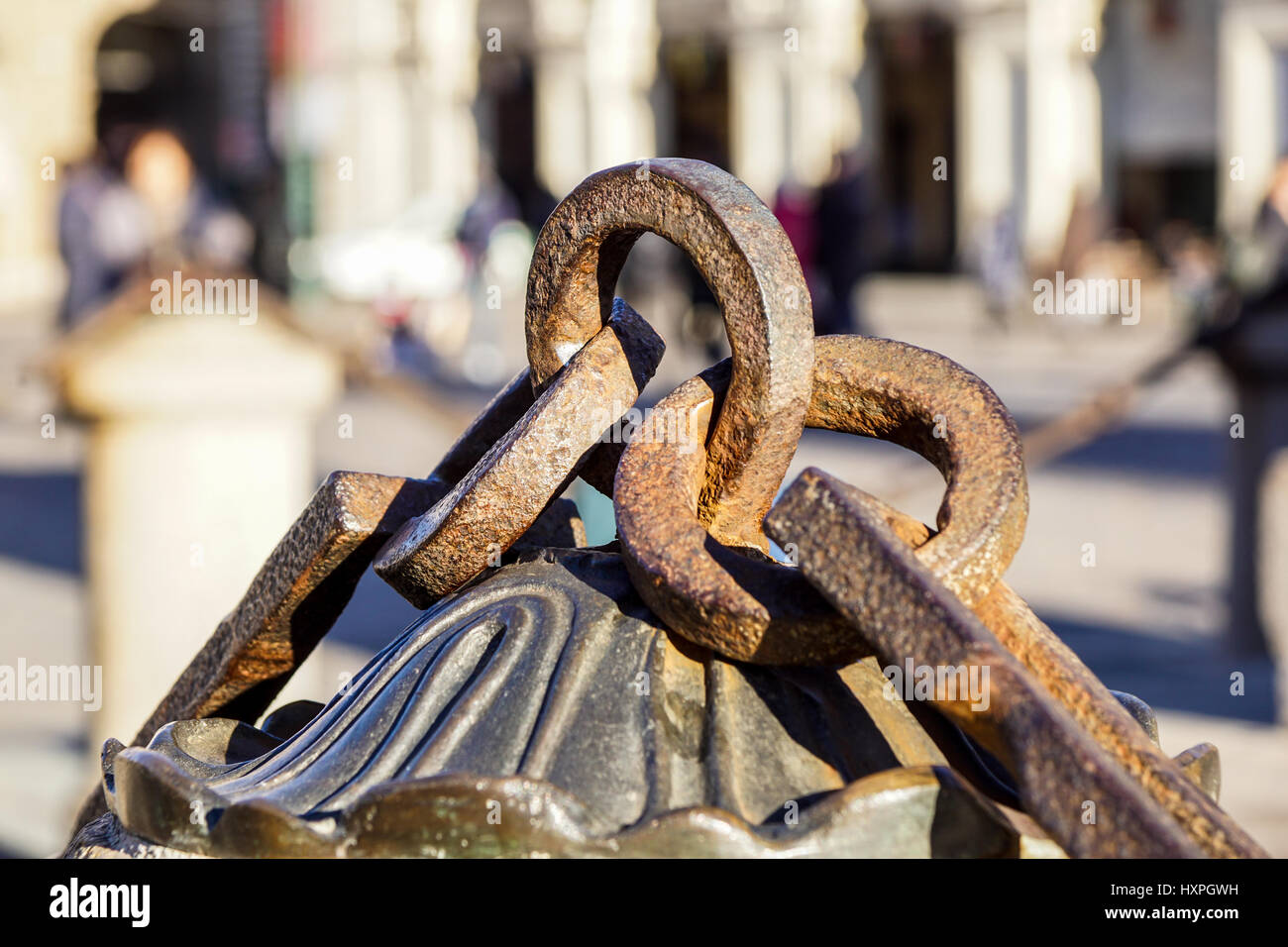 Metal chain with big ring. Close up texture of rocky surface with iron chain and ring on it Stock Photo