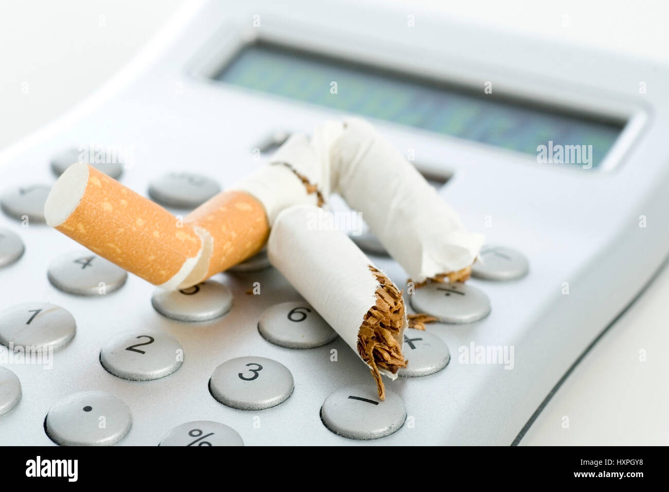 expressed cigarette on a pocket calculator, ausgedrückte Zigarette auf einem Taschenrechner Stock Photo