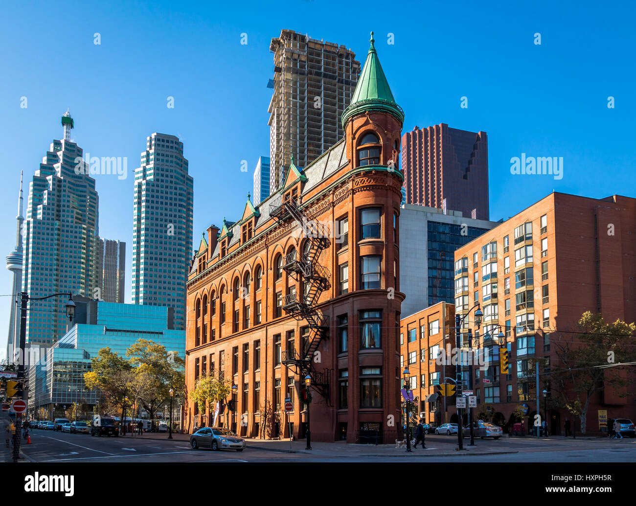Gooderham or Flatiron Building in downtown Toronto with CN Tower on background - Toronto, Ontario, Canada Stock Photo