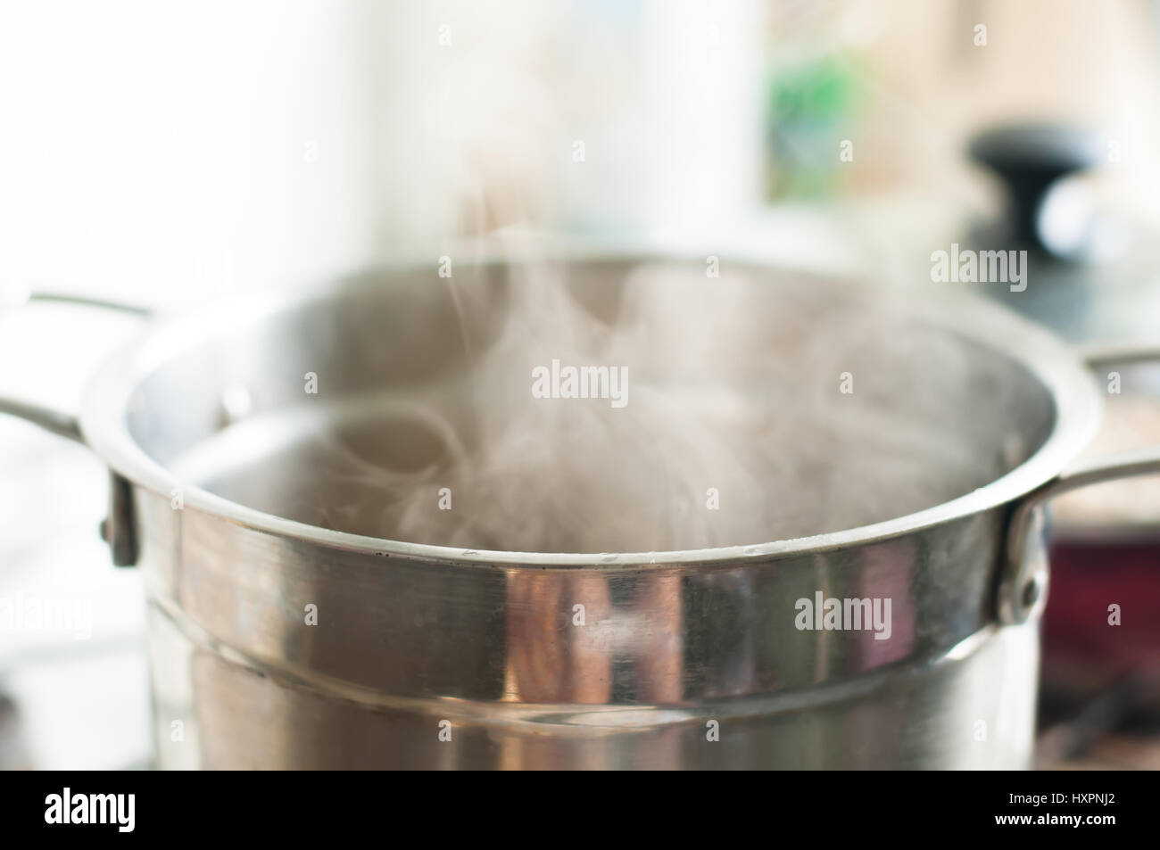 https://c8.alamy.com/comp/HXPNJ2/steel-pot-on-the-fire-with-water-inside-boiling-with-steam-HXPNJ2.jpg