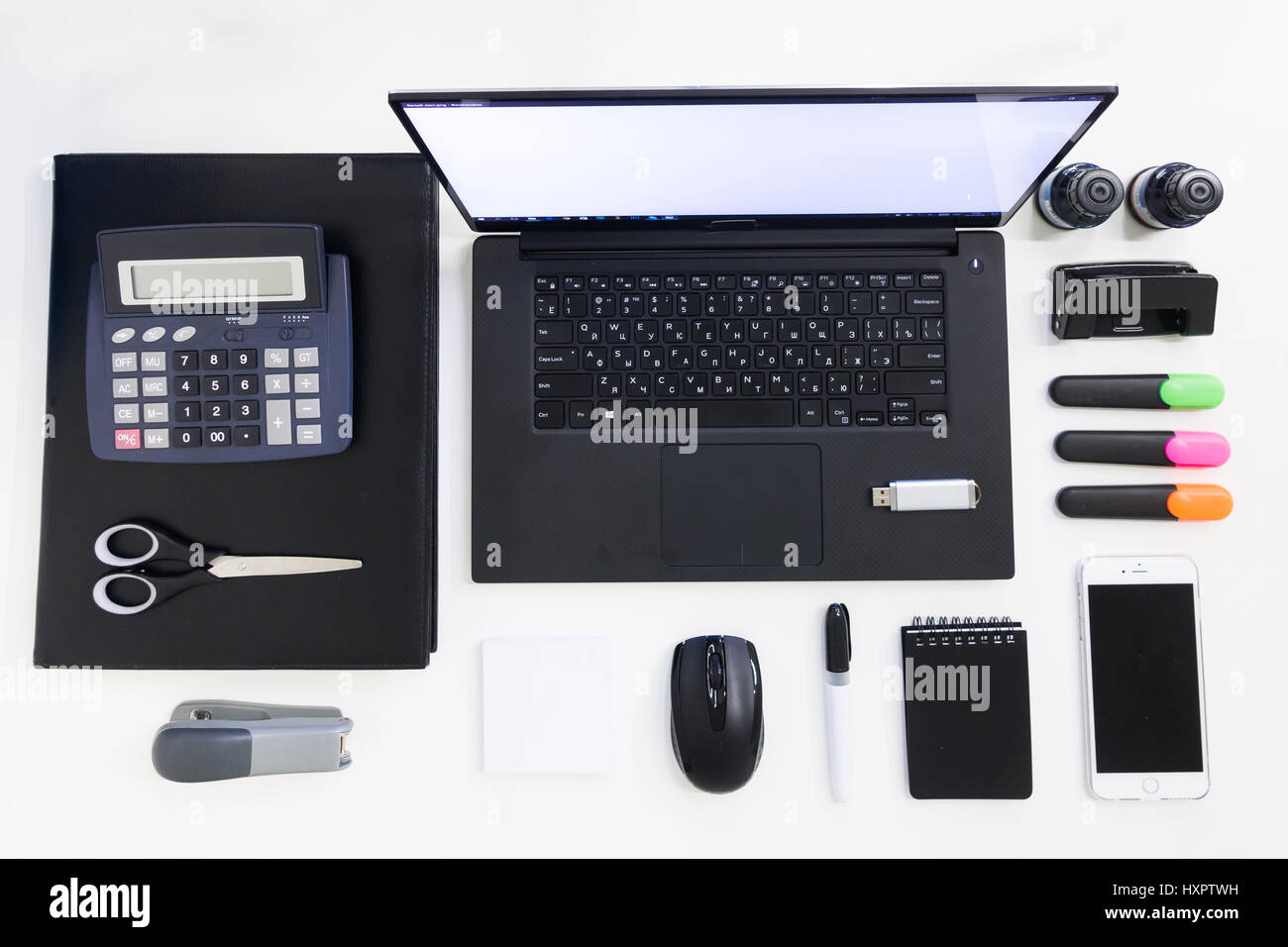 Black and white office supplies with laptop on office supplies desktop