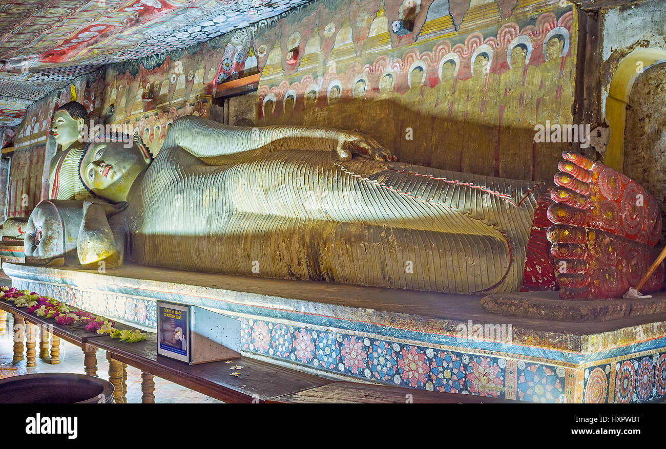 DAMBULLA, SRI LANKA - NOVEMBER 27, 2016: The ancient painted statue Reclining Lord Buddha in Maharaja Lena Cave (Great Kings) of Dambulla Temple Compl Stock Photo