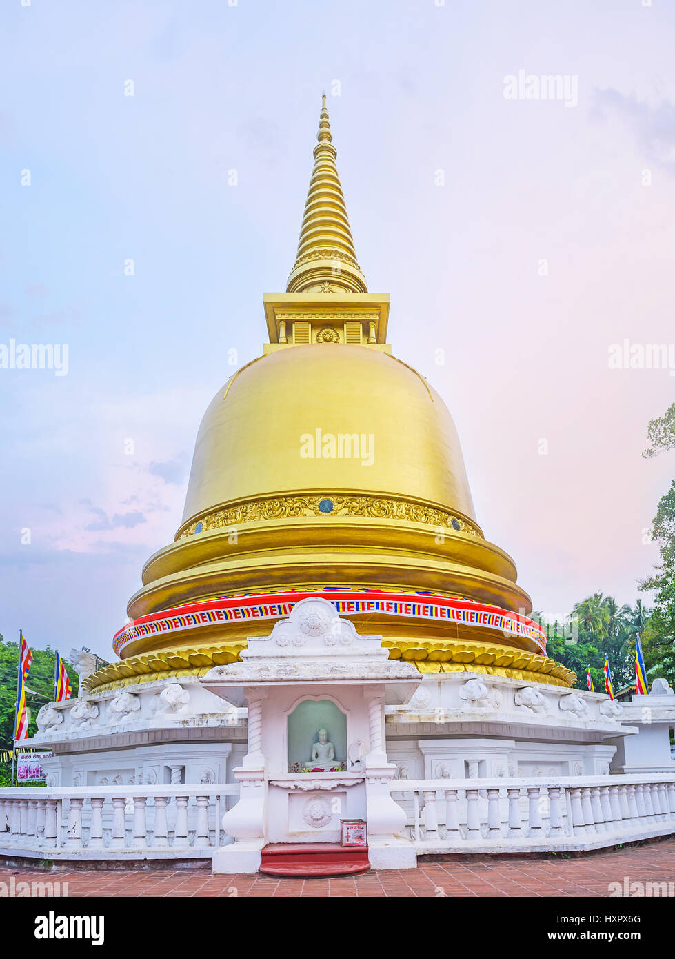 The gilt Pagoda of Dambulla Golden Temple with the statue of Meditating ...