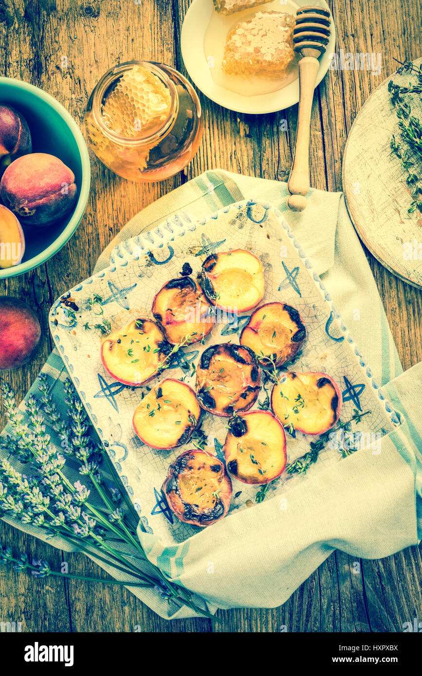 baked peaches with honey and thyme in vintage tray Stock Photo Alamy